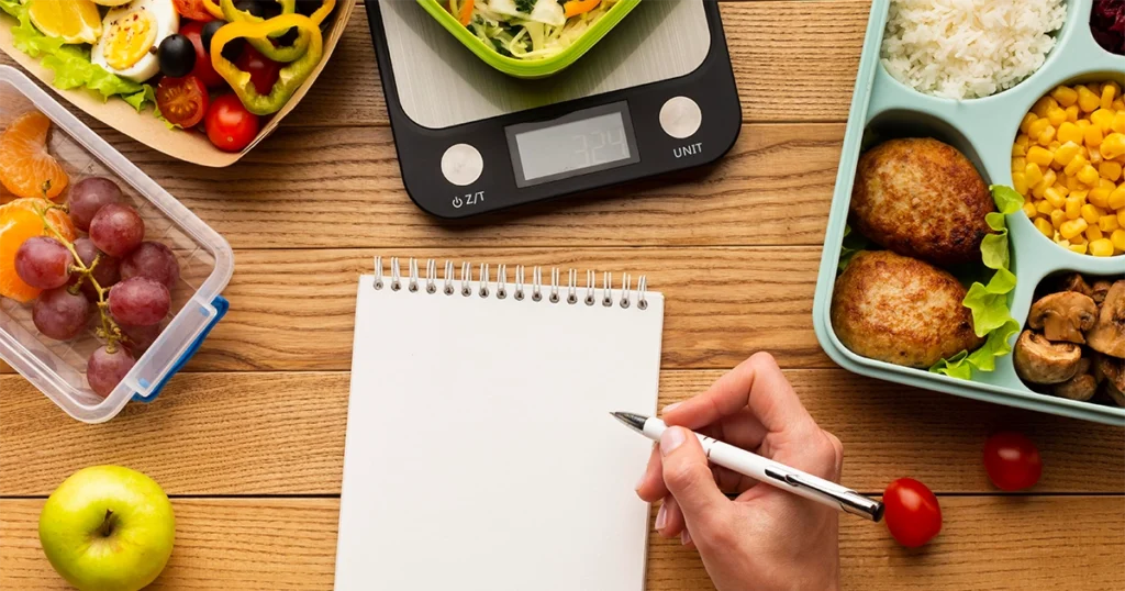 How to calculate macros for weight loss with healthy meal prep, food scale, and notebook