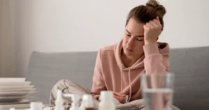 Tired woman with hormone fatigue resting on couch, exhausted and unable to focus