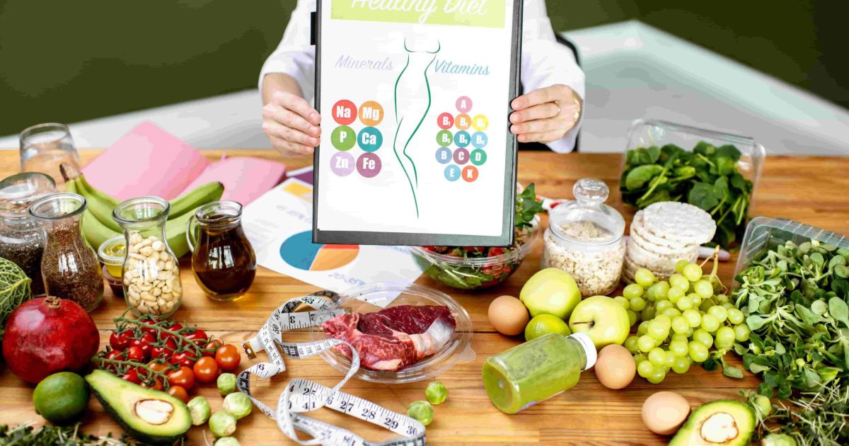 dietitian-with-vitamin-sheme-at-the-table-full-of-2025-03-15-04-51-06-utc-min